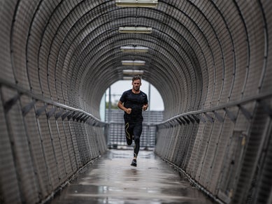 man running in compression clothing