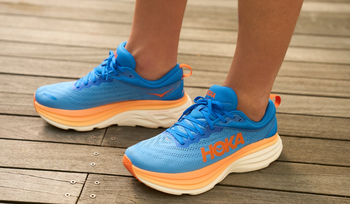 Close up of the feet of a runner wearing HOKA shoes for walking