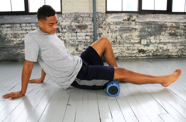 Man using a grid foam roller