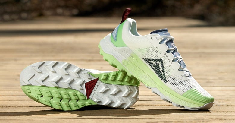 A pair of Nike Wildhorse shoes in cream color with light green accents