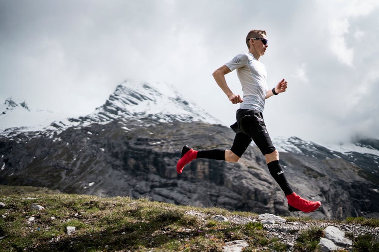 Male runner running through hills