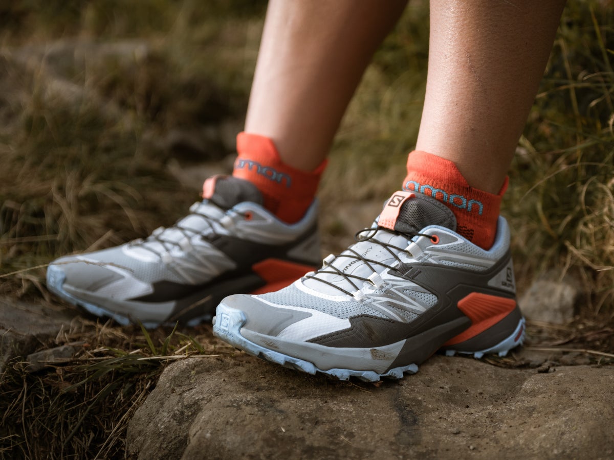 Close up of Salomon trail shoes with a light gray/blue upper and light blue outsole