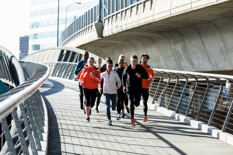 Group of runners running on a bridge.