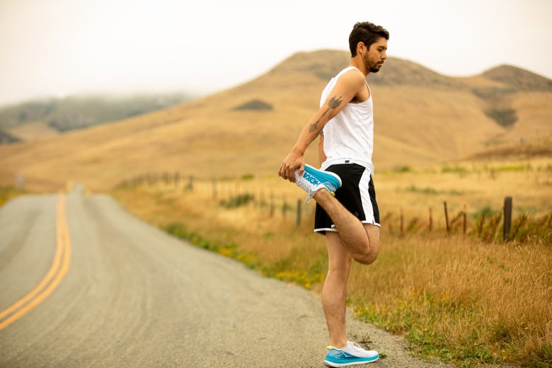 Runner stretching on the road