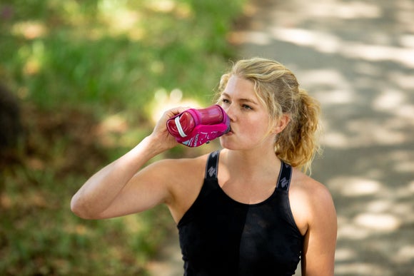 A runner drinking water