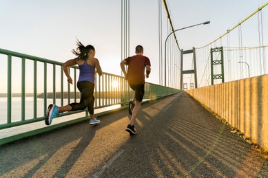 Runners  on city bridge